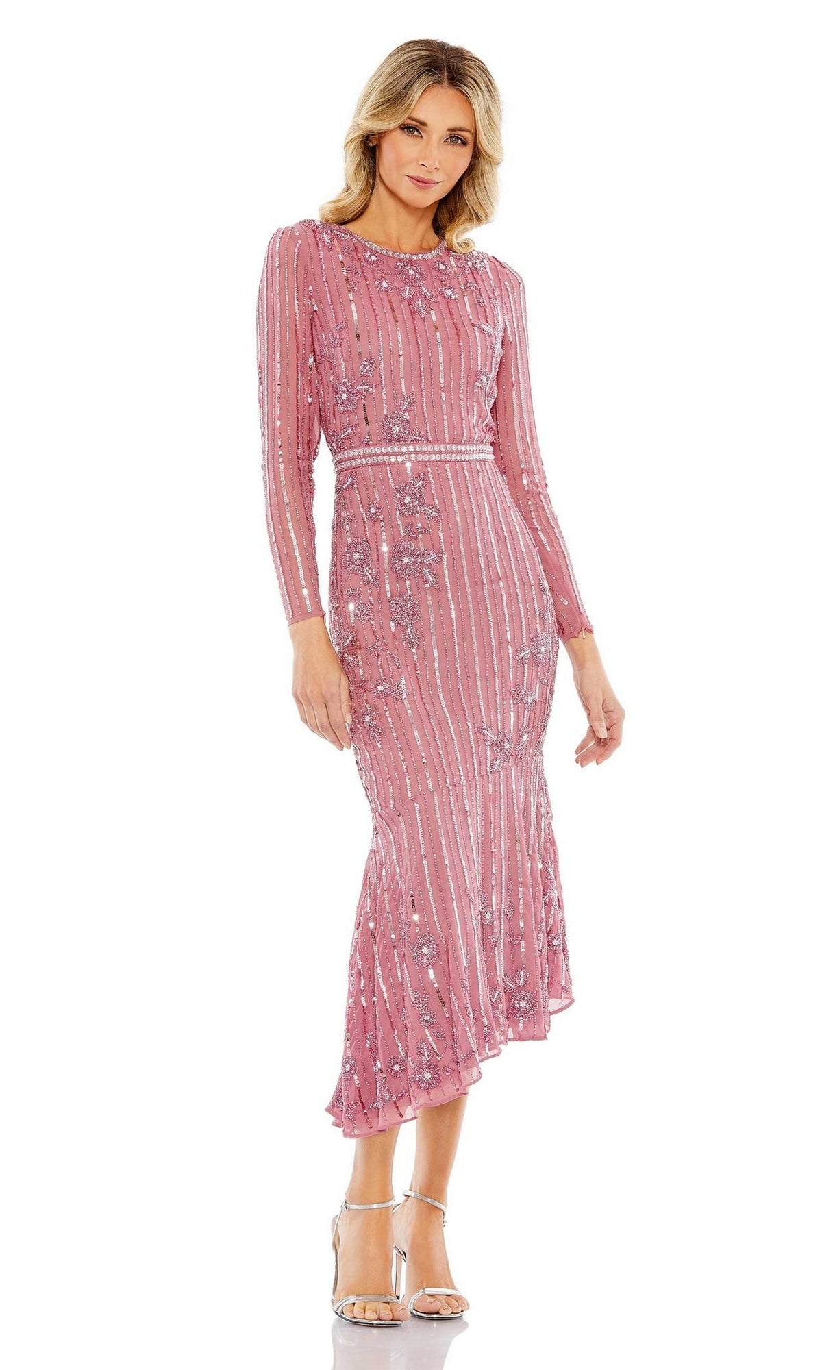 A woman wears the Mac Duggal 93627 Midi Sequin Wedding Guest Dress in pink with vertical stripes, styled with silver open-toe heels.